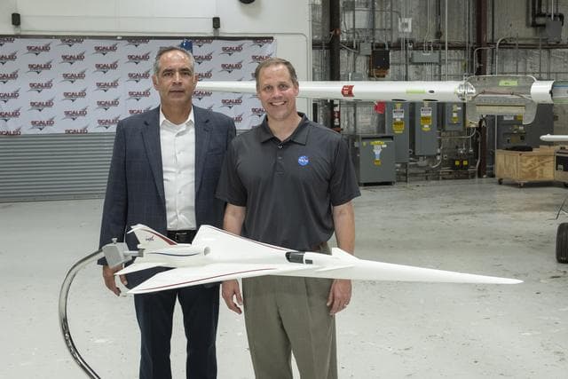 NASA image: NASA Administrator Bridenstine and Armstrong Flight Research Center's Center Director McBride stand beside model of NASA's Supersonic X-Plane, X-59 Quiet Supersonic Technology or QueSST at press event in Mojave Air & Space Port in California