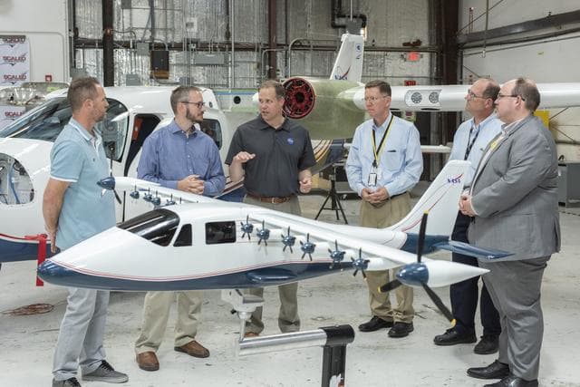 Armstrong X-57 team brief NASA Administrator Bridenstine about the progress of making a combustion aircraft into an all-electric airplane. X-57 is in Scaled Composites hangar at Mojave Air & Space Port in California. Model of the final aircraft design sta