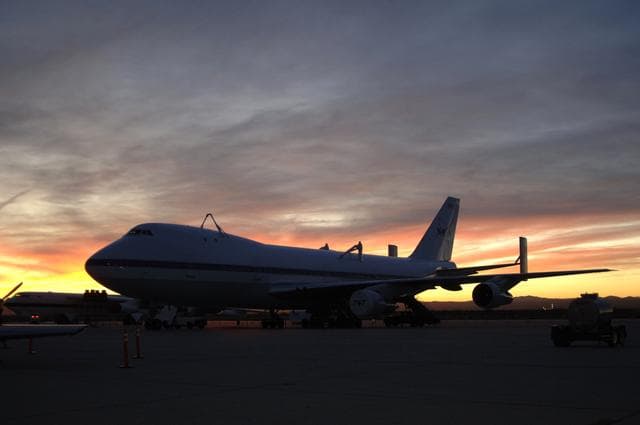 NASA image: One of NASA's two modified Boeing 747 Shuttle Carrier Aircraft is silhouetted against the morning sky at sunrise on the ramp at Edwards Air Force Base