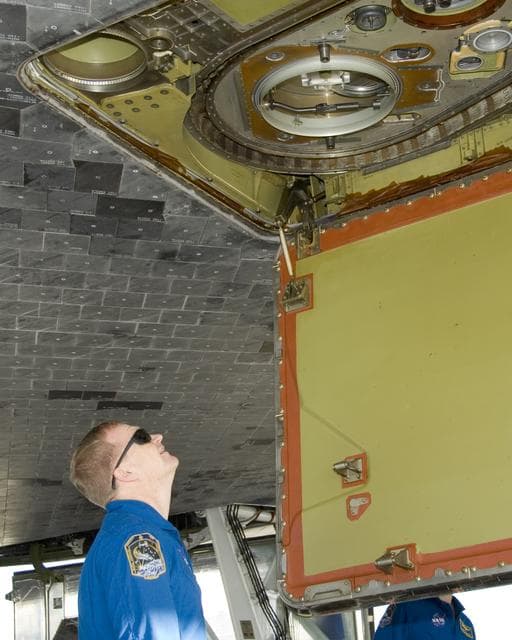 NASA image: STS-126 pilot Eric Boe inspects the liquid oxygen line connection on the belly of Space Shuttle Endeavour following landing at Edwards Air Force Base Sunday