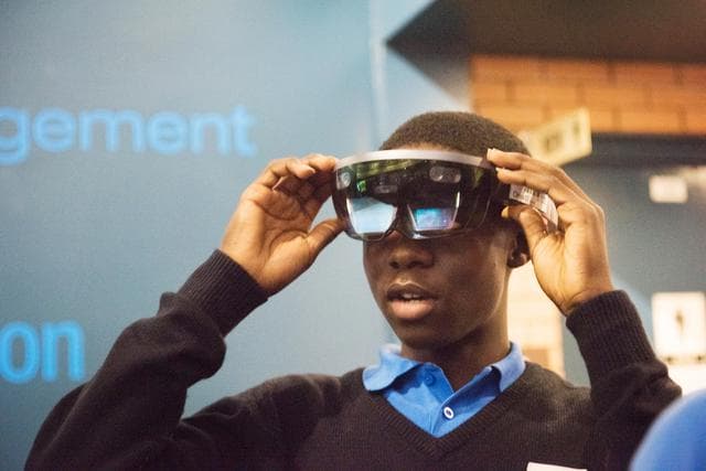 NASA image: During Avaiation Day, 2018, a Participant uses a Microsoft HoloLens Virtual Reality Headset to view a NASA Created Immersive Visualization