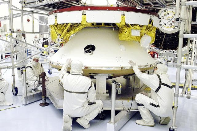 NASA image: KENNEDY SPACE CENTER, FLA. - The Mars Exploration Rover 2 (MER-2) undergoes a weight and center of gravity determination in the Payload Hazardous Servicing Facility.  NASA's twin Mars Exploration Rovers are designed to study the history of water on Mars. These robotic geologists are equipped with a robotic arm, a drilling tool, three spectrometers, and four pairs of cameras that allow them to have a human-like, 3D view of the terrain. Each rover could travel as far as 100 meters in one day to act as Mars scientists' eyes and hands, exploring an environment where humans can't yet go.  Launch of MER-2 is scheduled for June 5 from Cape Canaveral Air Force Station.