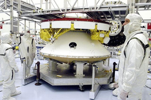 NASA image: KENNEDY SPACE CENTER, FLA. -  The Mars Exploration Rover 2 (MER-2) undergoes a weight and center of gravity determination in the Payload Hazardous Servicing Facility.  NASA's twin Mars Exploration Rovers are designed to study the history of water on Mars. These robotic geologists are equipped with a robotic arm, a drilling tool, three spectrometers, and four pairs of cameras that allow them to have a human-like, 3D view of the terrain. Each rover could travel as far as 100 meters in one day to act as Mars scientists' eyes and hands, exploring an environment where humans can't yet go.  Launch of MER-2 is scheduled for June 5 from Cape Canaveral Air Force Station.