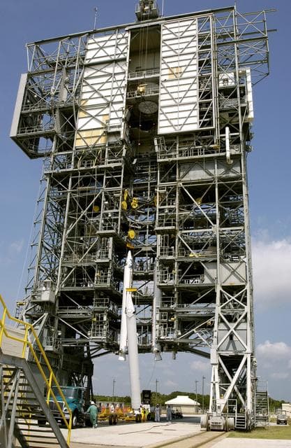 NASA image: KENNEDY SPACE CENTER, FLA. - A third solid rocket booster (SRB) is lifted up the launch tower on Launch Complex 17-A, Cape Canaveral Air Force Station.  They are three of nine SRBs that will be mated to the Delta rocket to launch Mars Exploration Rover 2 (MER-2). NASA’s twin Mars Exploration Rovers are designed to study the history of water on Mars. These robotic geologists are equipped with a robotic arm, a drilling tool, three spectrometers, and four pairs of cameras that allow them to have a human-like, 3D view of the terrain. Each rover could travel as far as 100 meters in one day to act as Mars scientists' eyes and hands, exploring an environment where humans can’t yet go.  MER-2 is scheduled to launch June 5 as MER-A.  MER-1 (MER-B) will launch June 25.
