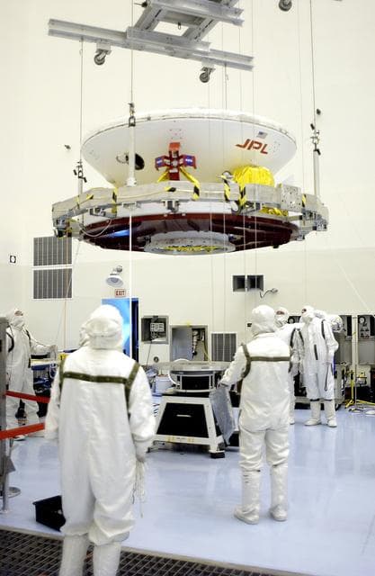 NASA image: KENNEDY SPACE CENTER, FLA. - In the Payload Hazardous Servicing Facility, the Mars Exploration Rover 2 (MER-2) is moved to a spin table.  NASA’s twin Mars Exploration Rovers are designed to study the history of water on Mars. These robotic geologists are equipped with a robotic arm, a drilling tool, three spectrometers, and four pairs of cameras that allow them to have a human-like, 3D view of the terrain. Each rover could travel as far as 100 meters in one day to act as Mars scientists' eyes and hands, exploring an environment where humans can’t yet go.  The MER-2 is scheduled to launch June 5 from Launch Pad 17-A, Cape Canaveral Air Force Station.