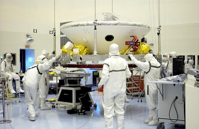 NASA image: KENNEDY SPACE CENTER, FLA. -  In the Payload Hazardous Servicing Facility, workers prepare to mate the Mars Exploration Rover-2 (MER-2) to the third stage of a Delta II rocket for launch on June 5.  NASA’s twin Mars Exploration Rovers are designed to study the history of water on Mars. These robotic geologists are equipped with a robotic arm, a drilling tool, three spectrometers, and four pairs of cameras that allow them to have a human-like, 3D view of the terrain. Each rover could travel as far as 100 meters in one day to act as Mars scientists' eyes and hands, exploring an environment where humans can’t yet go.  MER-1 (MER-B) will launch June 25.