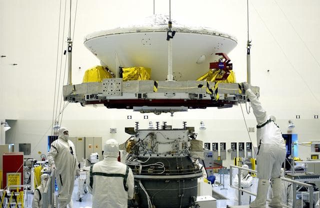 NASA image: KENNEDY SPACE CENTER, FLA. -  In the Payload Hazardous Servicing Facility, workers prepare to mate the Mars Exploration Rover-2 (MER-2) to the third stage of a Delta II rocket for launch on June 5.  NASA’s twin Mars Exploration Rovers are designed to study the history of water on Mars. These robotic geologists are equipped with a robotic arm, a drilling tool, three spectrometers, and four pairs of cameras that allow them to have a human-like, 3D view of the terrain. Each rover could travel as far as 100 meters in one day to act as Mars scientists' eyes and hands, exploring an environment where humans can’t yet go.  MER-1 (MER-B) will launch June 25.
