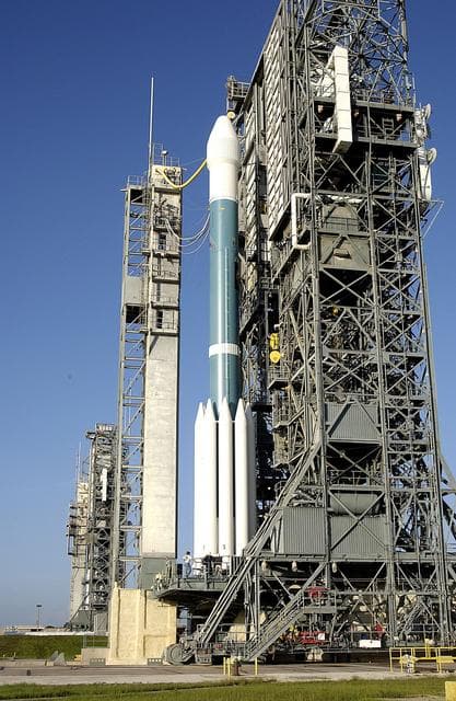 NASA image: KENNEDY SPACE CENTER, FLA. -  On Launch Complex 17-A, Cape Canaveral Air Force Station, the launch tower begins to roll back from the Boeing Delta II rocket and its Mars Exploration Rover (MER-A) payload in preparation for a second attempt at launch.  The first attempt on June 8, 2003, was scrubbed due to bad weather in the vicinity.  MER-A is the first of two rovers being launched to Mars.  When the two rovers arrive at Mars in 2004, they will bounce to airbag-cushioned landings at sites offering a balance of favorable conditions for safe landings and interesting science. The rovers see sharper images, can explore farther and examine rocks better than anything that has ever landed on Mars.  The designated site for MER-A mission is Gusev Crater, which appears to have been a crater lake.  The second rover, MER-B, is scheduled to launch June 25.