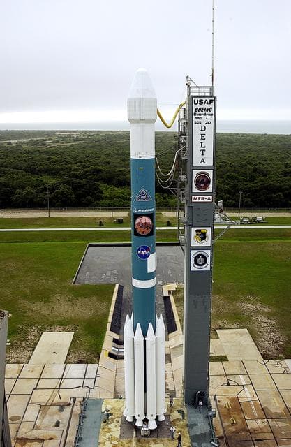 NASA image: KENNEDY SPACE CENTER, FLA. -  On Launch Complex 17-A, Cape Canaveral Air Force Station, the Boeing Delta II rocket and its Mars Exploration Rover (MER-A) payload are free of the tower  and ready for launch.  This will be the third launch attempt in as many days after weather concerns postponed the launches June 8 and June 9.  MER-A is the first of two rovers being launched to Mars.  When the two rovers arrive at Mars in 2004, they will bounce to airbag-cushioned landings at sites offering a balance of favorable conditions for safe landings and interesting science. The rovers see sharper images, can explore farther and examine rocks better than anything that has ever landed on Mars.  The designated site for MER-A mission is Gusev Crater, which appears to have been a crater lake.  The second rover, MER-B, is scheduled to launch June 25.