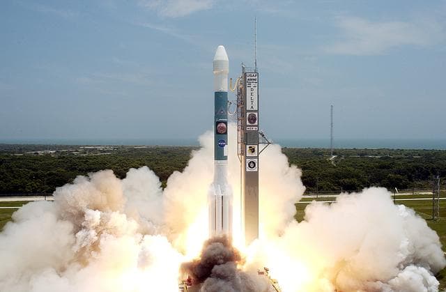 NASA image: KENNEDY SPACE CENTER, FLA. -   With a glimpse of the Atlantic Ocean over the horizon, the Delta II rocket with its Mars Exploration Rover (MER-A) payload leaps off the launch pad into the blue sky to begin its journey to Mars.  Liftoff occurred on time at 1:58 p.m. EDT from Launch Complex 17-A, Cape Canaveral Air Force Station.  MER-A, known as "Spirit," is the first of two rovers being launched to Mars. When the two rovers arrive at the red planet in 2004, they will bounce to airbag-cushioned landings at sites offering a balance of favorable conditions for safe landings and interesting science. The rovers see sharper images, can explore farther and examine rocks better than anything that has ever landed on Mars. The designated site for the MER-A mission is Gusev Crater, which appears to have been a crater lake. The second rover, MER-B, is scheduled to launch June 25