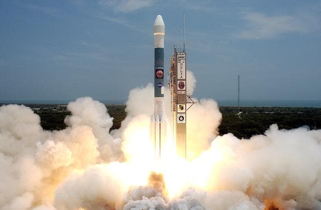 NASA image: KENNEDY SPACE CENTER, FLA. -   Surrounded by smoke and steam, the Delta II rocket with its Mars Exploration Rover (MER-A) payload hurtles through it into the blue sky to begin its journey to Mars.  Liftoff occurred on time at 1:58 p.m. EDT from Launch Complex 17-A, Cape Canaveral Air Force Station.  MER-A, known as "Spirit," is the first of two rovers being launched to Mars. When the two rovers arrive at the red planet in 2004, they will bounce to airbag-cushioned landings at sites offering a balance of favorable conditions for safe landings and interesting science. The rovers see sharper images, can explore farther and examine rocks better than anything that has ever landed on Mars. The designated site for the MER-A mission is Gusev Crater, which appears to have been a crater lake. The second rover, MER-B, is scheduled to launch June 25.