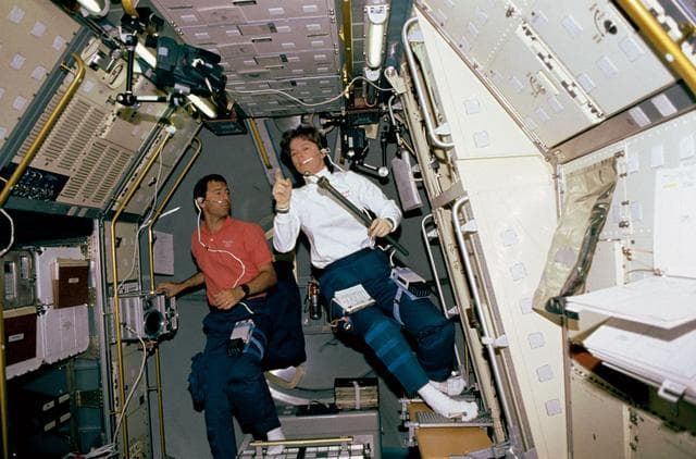 NASA image: Crewmember working on the spacelab Drop Physics Module, Rack 9.