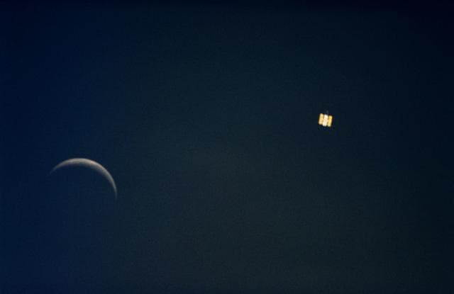 Onboard view from STS-61 of the Hubble Space Telescope and moon together