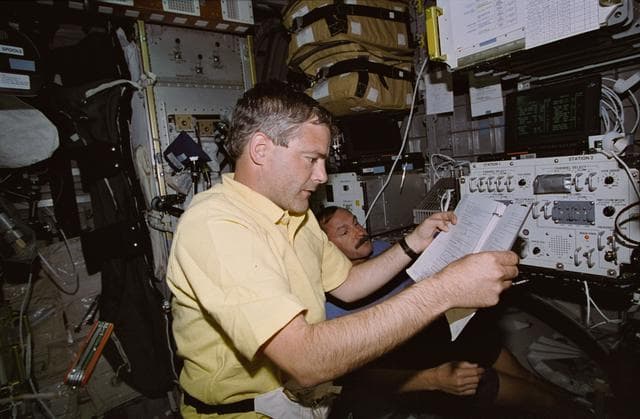NASA image: Astronaut Garneau working with Audio Control System panel